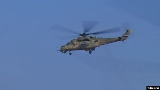 A helicopter flies over Anbar Province during Iraqi military air strikes.