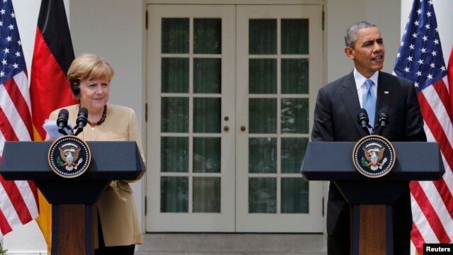 U.S. President Barack Obama (right) and German Chancellor Angela Merkel address a joint news conference in the Rose Garden of the White House in Washington on May 2. 