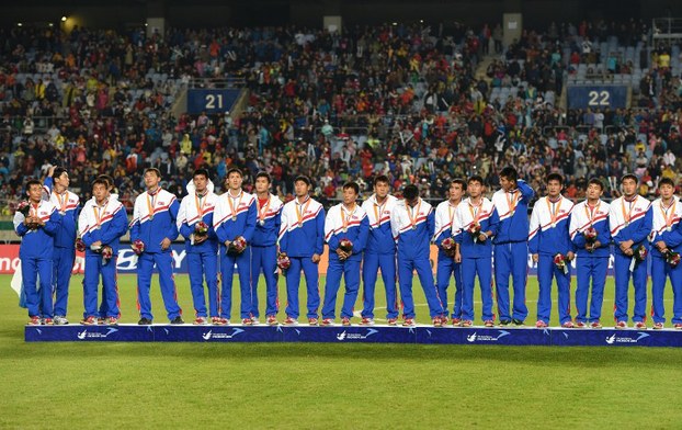 Members of the North Korean men's soccer team pose on the podium following their loss to South Korea in the gold medal match of the 17th Asian Games in Incheon, Oct. 2, 2014.
