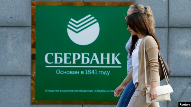 Women walk past a Sberbank office in Moscow on September 12.