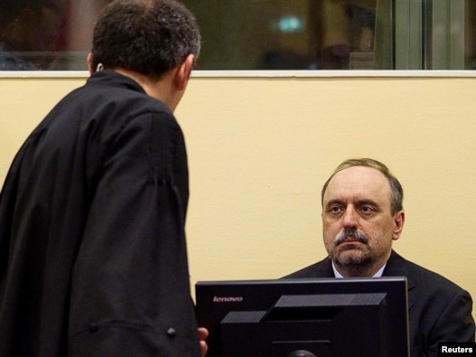 Goran Hadzic (right) makes his initial appearance to stand trial for alleged crimes against humanity before the International Criminal Tribunal for the former Yugoslavia (ICTY) in The Hague on July 25.