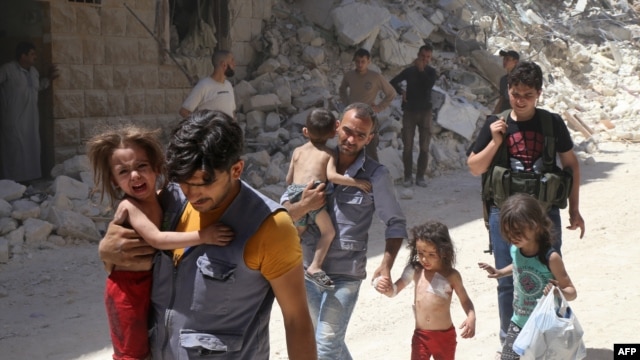 Syrian men carry injured children amid the rubble of destroyed buildings following air strikes on a rebel-held neighborhood of Aleppo.