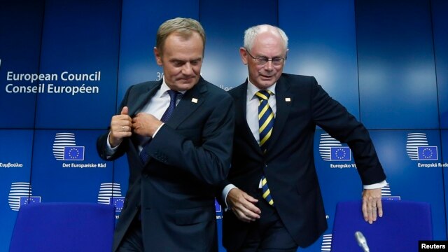 Newly elected European Council President Donald Tusk (left) holds a news conference with outgoing predecessor Herman Van Rompuy during a EU summit in Brussels on August 30.