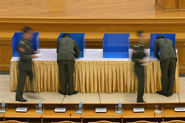 Military members of parliament cast their votes on a draft amendment to the constitution at a session of parliament in Naypyidaw, June 25, 2015.