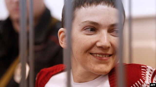 Ukrainian pilot Nadia Savchenko stands inside a defendant's cage during her hearing in the Basmanny district court in Moscow on February 10.