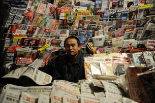 A newspaper vendor at his stall in Beijing, Oct. 25, 2011.