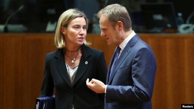 EU foreign policy chief Federica Mogherini (left) talks to European Council President Donald Tusk in Brussels on December 18.