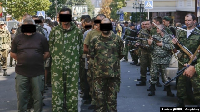 Correspondents say people watching the August 24 incident in Donetsk shouted 'Fascists!' and other abuse at the prisoners.