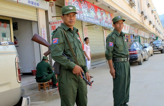 Ethnic Kokang soldiers stand outside a deserted market in Shan state in a file photo.