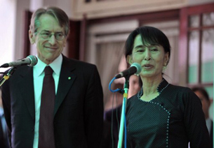Aung San Suu Kyi speaks to reporters with Giulio Terzi at her residence in Rangoon, April 26, 2012.