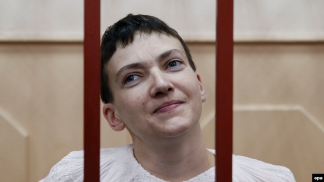 Ukrainian military pilot Nadia Savchenko stands inside a defendants' cage as she attends a court hearing in Moscow on April 17.