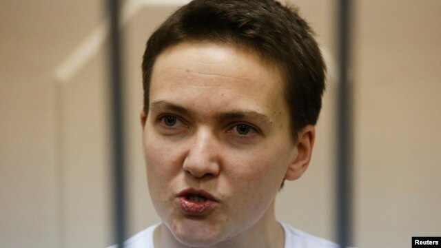 Ukrainian military pilot Nadia Savchenko speaks inside a defendants' cage as she attends a court hearing in Moscow in November 11.