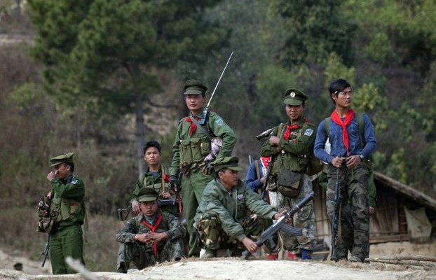 Ta'ang National Liberation Army soldiers stand guard outside a village in Mantong township in Shan state, Jan. 16, 2014.