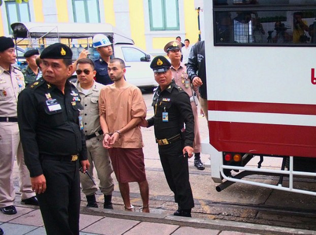 Adem Karadag arrives at a Thai military court for arraignment on charges related to the August 2015 fatal bombing at a Hindu shrine, Feb. 16, 2016.