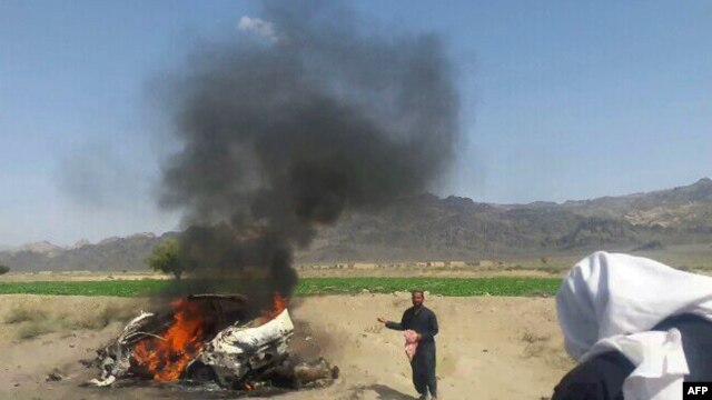 A car is seen on fire at the site of a U.S. drone strike in Pakistan that is believed to have killed Afghan Taliban leader Mullah Akthar Mansur.