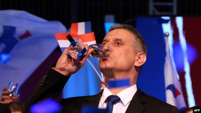 The leader of the conservative opposition Croatian Democratic Union party, Tomislav Karamarko, celebrates initial results.