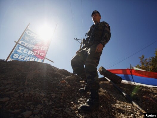 A KFOR soldier from France walks along barricades at the closed Serbia-Kosovo border crossing of Brnjak on October 19.