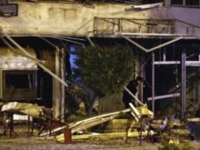 Serbia - Kosovo police officers work at the scene of a blast that two people dead and 11 injured in the center of the Kosovo capital Pristina, 24Sep2007