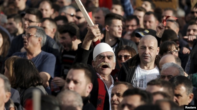 Demonstrators shout antigovernment slogans during a protest in Pristina on February 17. 