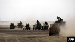 Syrian Democratic Forces units advance in an area northeast of Raqqa last month.