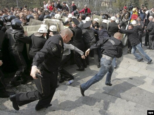 Police officers clash with demonstrators during anti-communist demonstrations in Chisinau on April 7.
