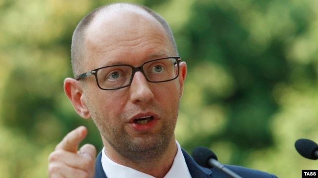 Ukrainian Prime Minister Arseny Yatsenyuk talks to reporters in Kyiv on August 8 about sanctions proposed by the Cabinet against 'individuals and legal entities financing terrorism and supporting the occupation of Crimea.'