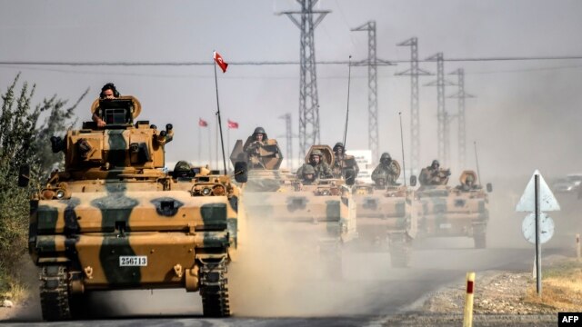 Turkish Army tanks drive to the Syrian border town of Jarabulus on August 25.