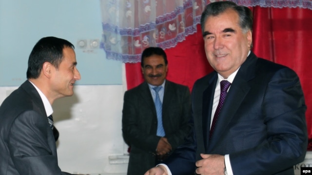 Tajik President Emomali Rahmon (right) at a polling station during presidential elections in Dushanbe on November 6.