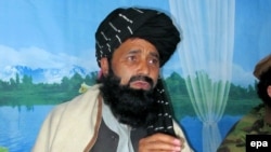 Azam Tariq, a spokesman of the banned militant group Tehrik-e Taliban Pakistan, speaks at an undisclosed location near the Afghan border in February 2014.