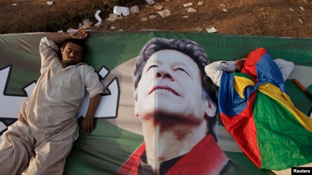 Supporters of Imran Khan, the head of the Pakistan Tehrik-e Insaf political party, take a nap on Khan's campaign banner during what has been dubbed a 'freedom march' in Islamabad on August 25.