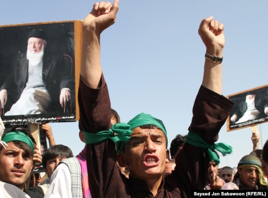 Supporters of slain former Afghan President Burhanuddin Rabbani shout slogans and hold up his portrait during a protest against the Taliban and Pakistan in Kabul on September 27.
