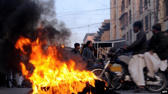 Tires burning during a protest in Karachi after the deadly attack.
