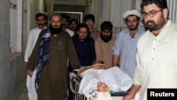 People move a stretcher with an injured man, who was shot after militants attacked a rally organized by the PTM in Wana, at a hospital in Dera Ismail Khan, on June 4.