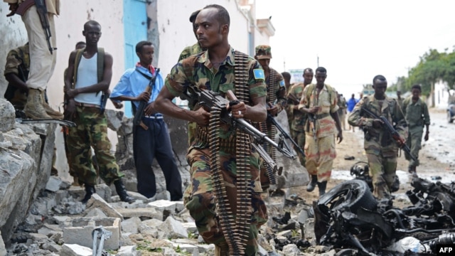 Somali National Government soldiers at the scene after Al-Qaeda-linked Shebab insurgents blasted their way into the UN compound in Mogadishu on June 19.