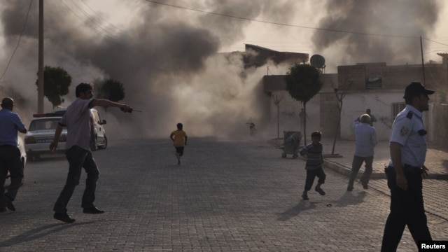 Smoke rises over the streets after a mortar shell landed from Syria in the border village of Akcakale on October 3.