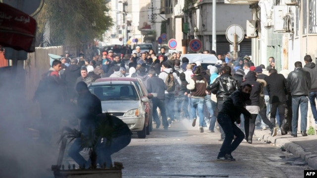 Protesters clash with security forces outside the Interior Ministry in Tunis on February 7.
