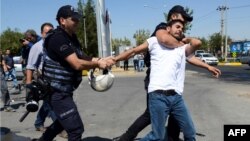 Turkish police detain a teacher during a protest in Diyarbakir on September 9. More than 11,000 teachers in Turkey have been suspended for alleged links to the outlawed Kurdistan Workers Party.