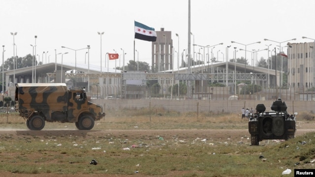 Turkish troops take up position at the Akcakale border gate in southern Sanliurfa province on the border with Syria on October 7.