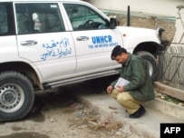 A police officer inspects the site where John Solecki was kidnapped in Quetta.