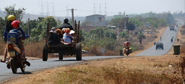 Montagnard villagers drive along a road in Gia Lai province in Vietnam's Central Highlands on March 13, 2013.