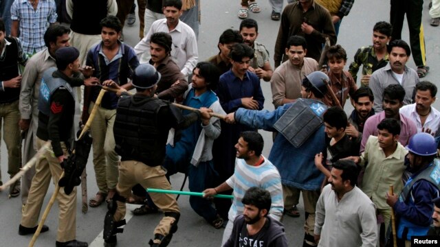 Protesters from Pakistan's Christian community clash with riot police on March 16, a day after suicide attacks on two churches in Lahore.