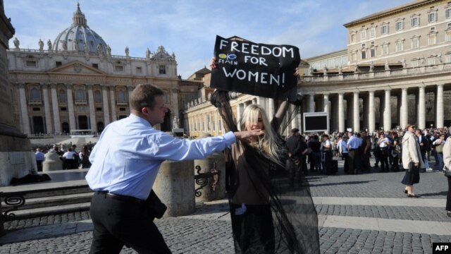A Femen activist is stopped by security in front of St Peter's Basilica in Rome in November.
