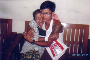 Phyo Sithu, a former child soldier in the Burmese military, with his mother following his release from prison, Sept. 2, 2011.