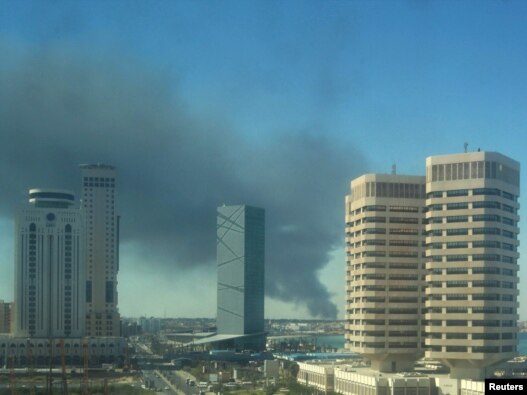 Smoke rises over the western side of Tripoli on October 14.