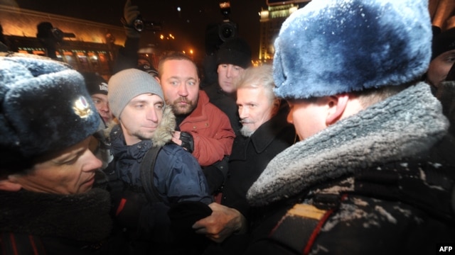 Russian police arrest opposition leader Eduard Limonov (second from right) during a protest in central Moscow on December 31.