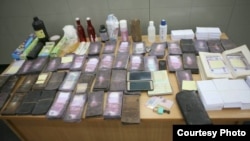 Police also seized materials capable of being used for counterfeiting, a French resident permit, and two Cameroonian passports.