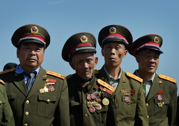 Retired Chinese military officers from Sichuan province tour Tiananmen Square in Beijing, Sept. 20, 2013.
