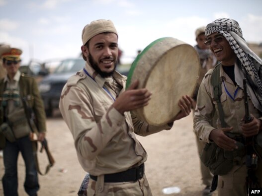 Libyan National Transitional Council fighters celebrate in the center of Bani Walid on October 17.