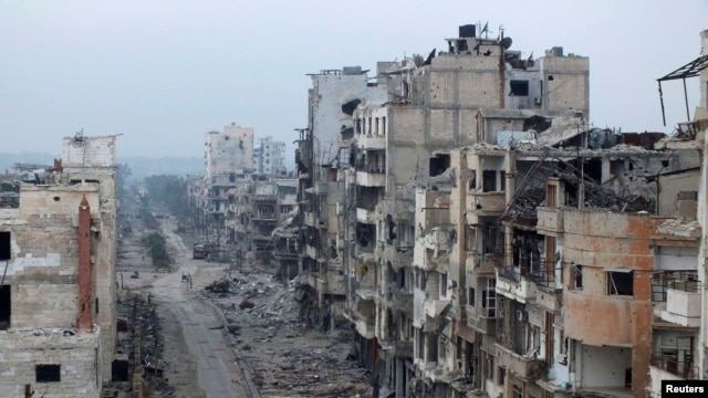 Damaged buildings line a street in the besieged area of Homs.