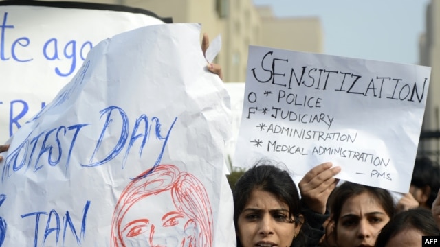 Indian lawyers shout slogans as they hold placards during a protest at the entrance to Saket District Court in New Delhi earlier this month.